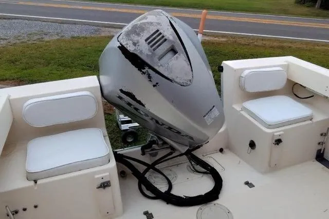 Slide: The Image of 1996 Parker 2110 Walkaround boat with outboard motor and cushioned seating. - 12