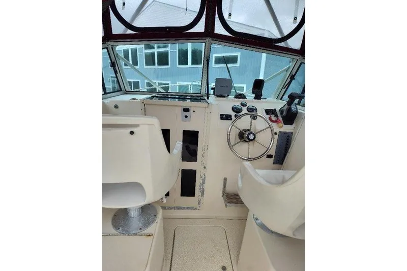 Slide: The Image of Interior view of 1996 Parker 2110 Walkaround boat cockpit with steering wheel and controls. - 13