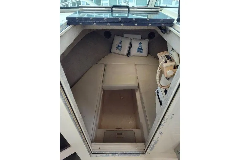 Slide: The Image of 1996 Parker 2110 Walkaround cabin interior with cushions and radio equipment. - 16