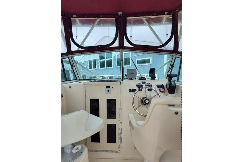Slide: The Image of Interior view of 1996 Parker 2110 Walkaround boat cockpit with steering wheel and controls. - 9