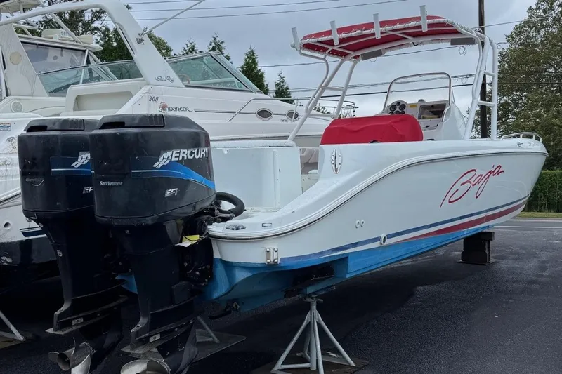 The Image of 2000 Baja 340 Sport Fisherman boat with dual Mercury outboard engines, docked on land. - 0