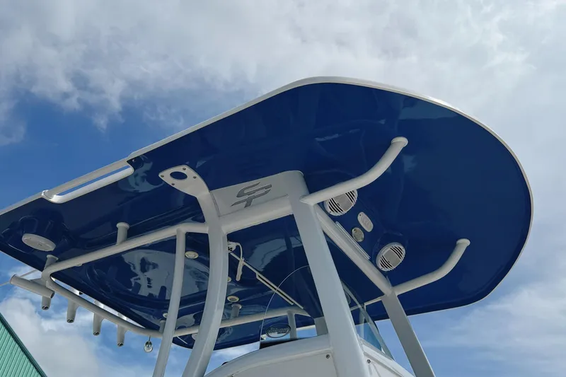 Slide: The Image of 2023 Sea Pro 239 DLX boat with blue T-top against cloudy sky. - 10