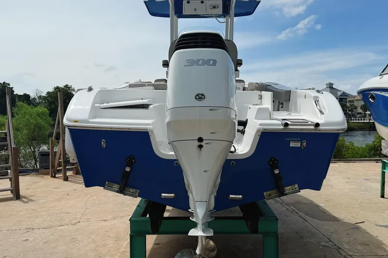 Slide: The Image of 2023 Sea Pro 239 DLX boat with powerful 300 engine, docked outdoors. - 11