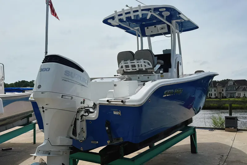 Slide: The Image of 2023 Sea Pro 239 DLX boat with Suzuki 300 engine, docked near waterfront homes. - 12