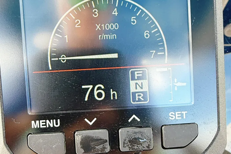 Slide: The Image of Close-up of a 2023 Sea Pro 239 DLX boat tachometer displaying 76 hours. - 17