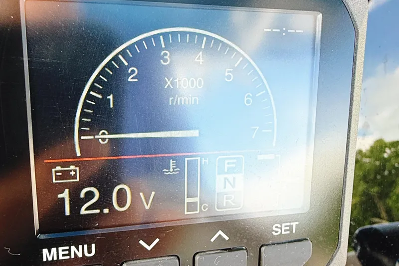 Slide: The Image of Close-up of 2023 Sea Pro 239 DLX boat dashboard displaying tachometer and voltage. - 18