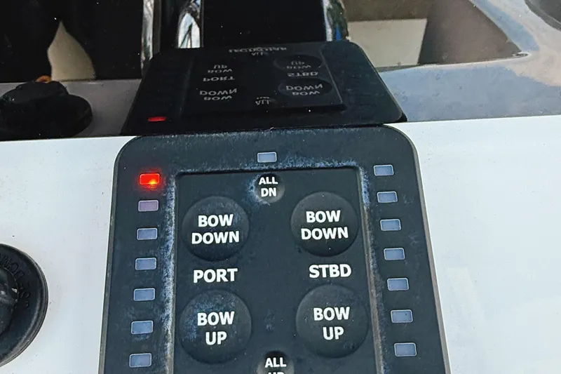 Slide: The Image of Control panel of a 2023 Sea Pro 239 DLX boat with trim tab buttons. - 19
