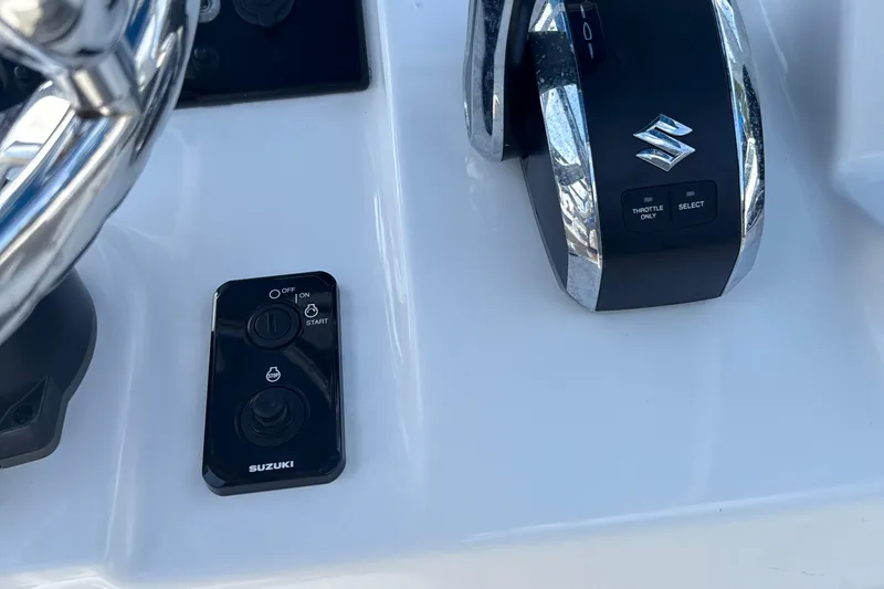 Slide: The Image of 2023 Sea Pro 239 DLX boat controls with Suzuki throttle and ignition system. - 21