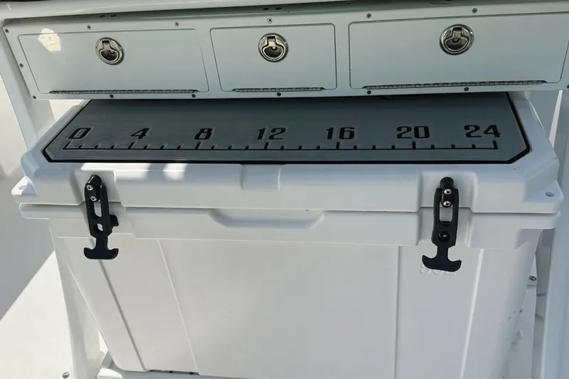 Slide: The Image of 2023 Sea Pro 239 DLX boat storage with measuring board and secure latches. - 24
