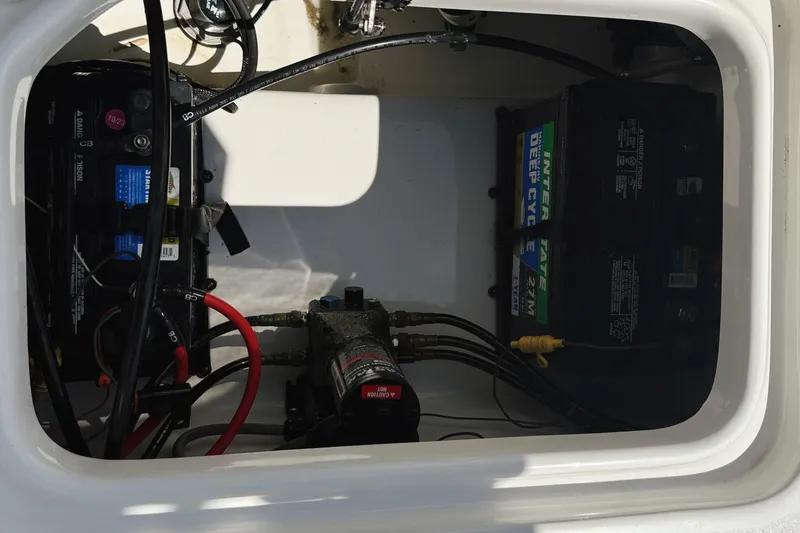 Slide: The Image of 2023 Sea Pro 239 DLX boat battery compartment with wiring and deep cycle batteries. - 25