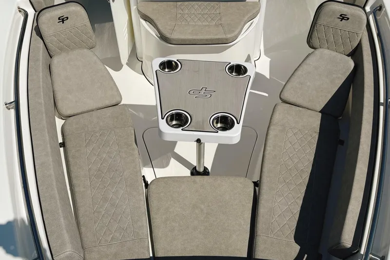 Slide: The Image of 2023 Sea Pro 239 DLX boat interior with cushioned seating and table. - 26