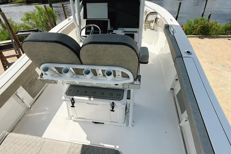 Slide: The Image of 2023 Sea Pro 239 DLX boat interior with dual seats and rod holders. - 31