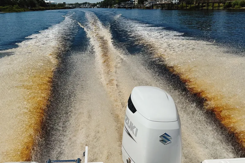 Slide: The Image of 2023 Sea Pro 239 DLX boat cruising, creating dynamic water wake. - 34