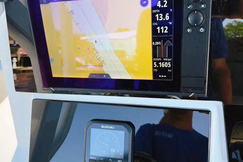 Slide: The Image of 2023 Sea Pro 239 DLX boat dashboard with navigation and Suzuki engine display. - 37