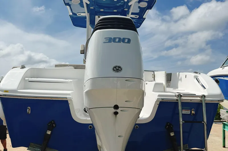 Slide: The Image of 2023 Sea Pro 239 DLX boat with powerful 300 horsepower engine, blue and white design. - 9