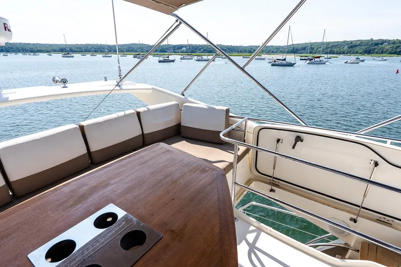 Slide: The Image of Flybridge view on 2014 Prestige Yachts 550, overlooking serene waters and anchored boats. - 21
