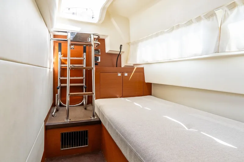 Slide: The Image of 2014 Prestige Yachts 550 Flybridge cabin interior with bed and ladder. - 28