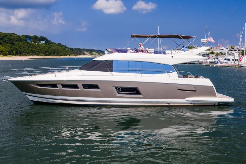 Slide: The Image of 2014 Prestige Yachts 550 Flybridge cruising on a scenic waterway. - 3
