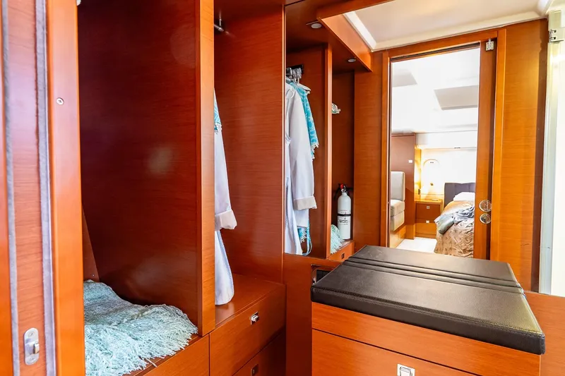 Slide: The Image of Luxurious interior of 2014 Prestige Yachts 550 Flybridge with wooden cabinetry and cozy bedroom. - 32