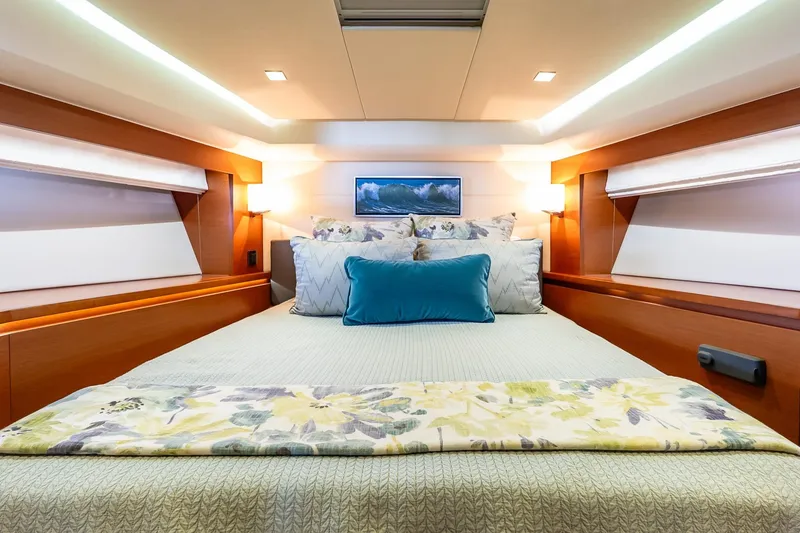 Slide: The Image of Luxurious bedroom interior of 2014 Prestige Yachts 550 Flybridge, featuring elegant bedding and lighting. - 41