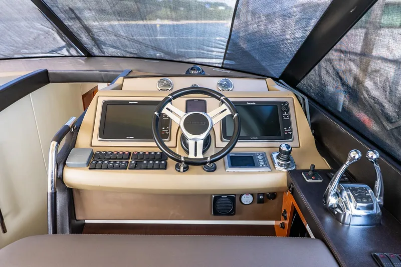 Slide: The Image of 2014 Prestige Yachts 550 Flybridge helm with modern navigation controls and steering wheel. - 46