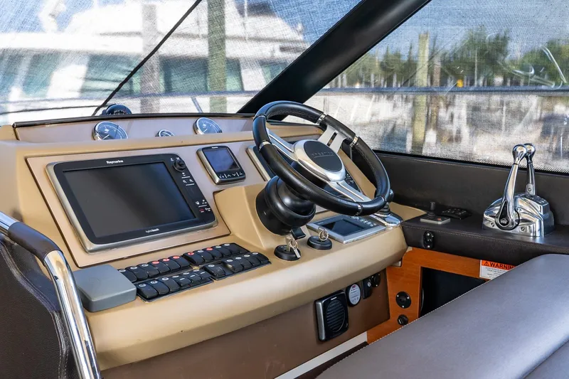 Slide: The Image of Cockpit of 2014 Prestige Yachts 550 Flybridge with steering wheel and navigation controls. - 48