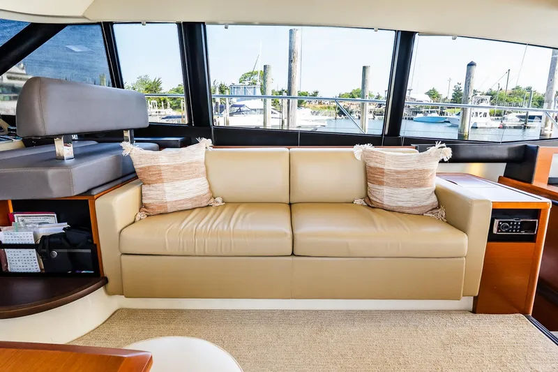 Slide: The Image of Luxurious interior of 2014 Prestige Yachts 550 Flybridge with beige sofa and decorative pillows. - 50