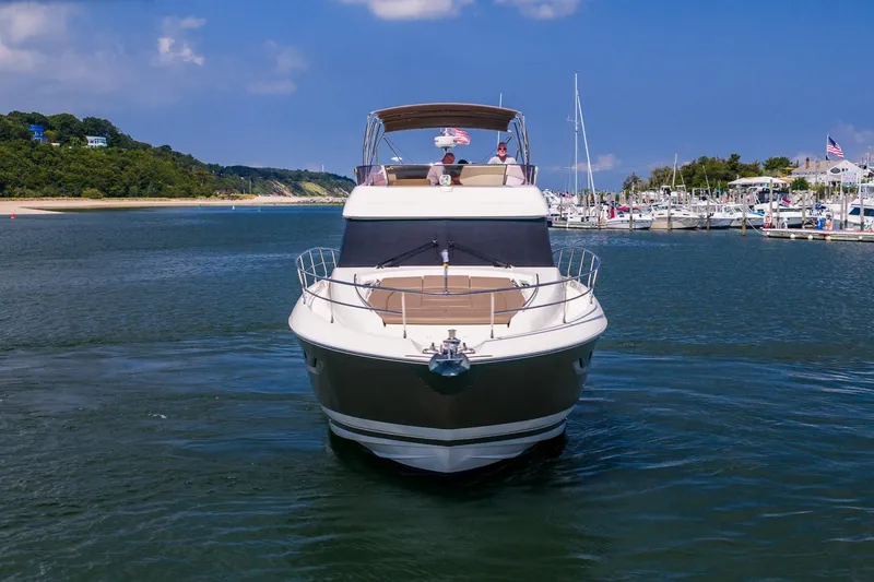 Slide: The Image of 2014 Prestige Yachts 550 Flybridge cruising in a scenic marina setting. - 58