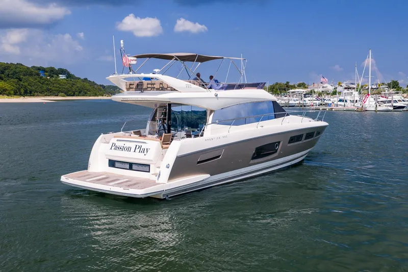 Slide: The Image of 2014 Prestige Yachts 550 Flybridge cruising in a scenic marina setting. - 6