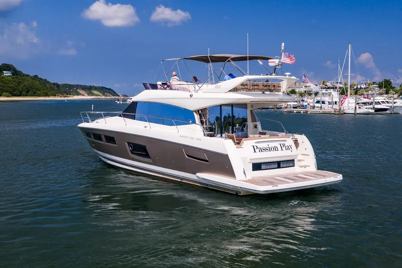 Slide: The Image of 2014 Prestige Yachts 550 Flybridge cruising in a scenic marina setting. - 61
