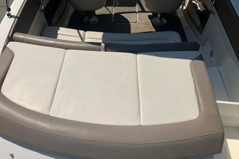 Slide: The Image of 2013 Sea Ray 210 SLX boat interior with cushioned seating and modern design. - 16