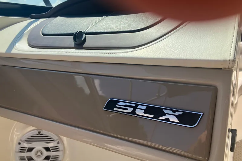 Slide: The Image of 2013 Sea Ray 210 SLX boat interior with SLX logo and speaker detail. - 20