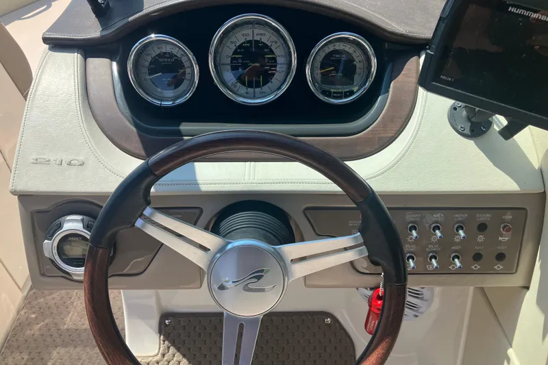 Slide: The Image of Steering wheel and dashboard of 2013 Sea Ray 210 SLX boat with gauges and controls. - 22