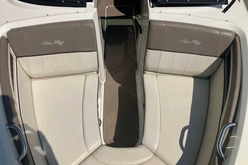 Slide: The Image of 2013 Sea Ray 210 SLX boat interior with beige and brown seating. - 25