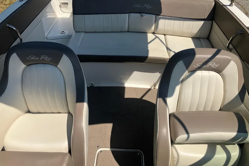 Slide: The Image of 2013 Sea Ray 210 SLX boat interior with beige and gray seating. - 27