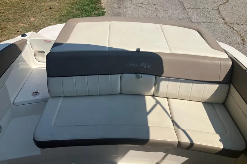 Slide: The Image of 2013 Sea Ray 210 SLX boat interior with beige and gray seating. - 28