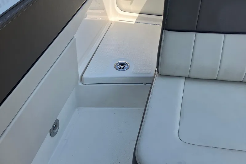 Slide: The Image of Interior seating of a 2013 Sea Ray 210 SLX boat, featuring white upholstery. - 29