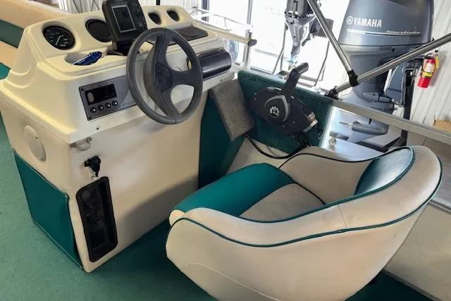 Slide: The Image of 1997 Crest Sport boat interior with steering wheel, control panel, and Yamaha engine. - 10