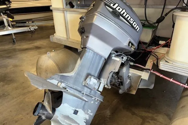 Slide: The Image of 1997 Crest Sport boat with Johnson outboard motor in a garage setting. - 17