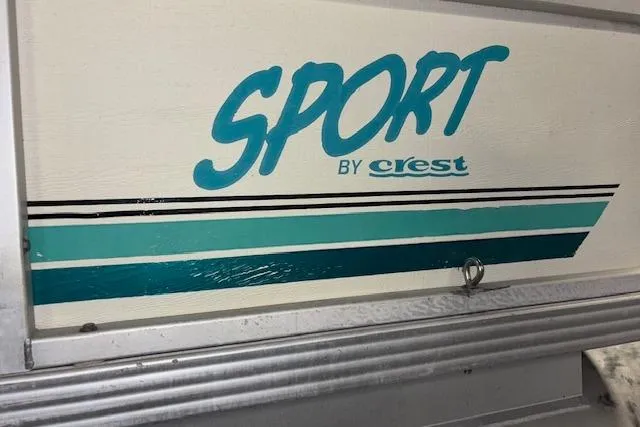 Slide: The Image of 1997 Crest Sport logo with teal and black stripes on a vehicle panel. - 18