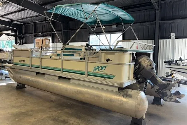 Slide: The Image of 1997 Crest Sport pontoon boat with canopy in indoor storage facility. - 3