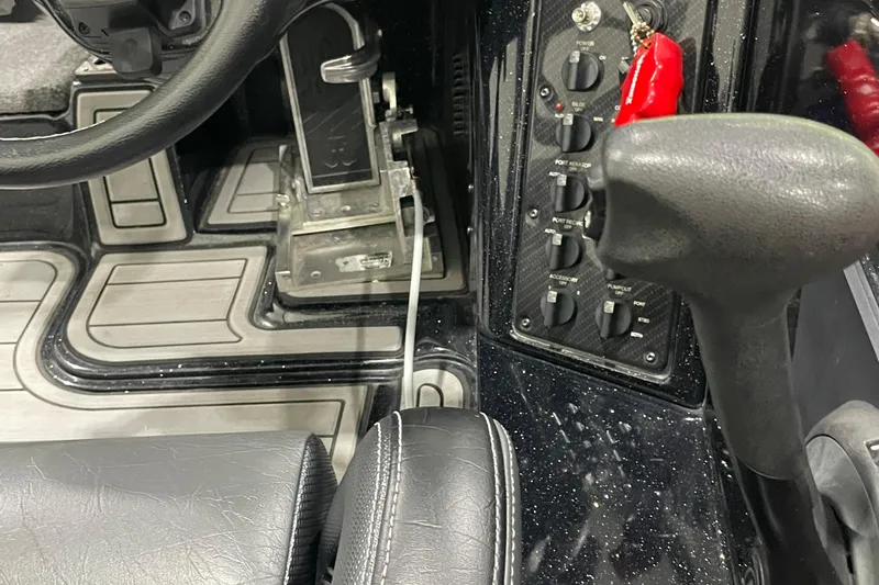 Slide: The Image of Interior of a 2021 Phoenix 21 PHX boat showing steering wheel and control panel. - 13