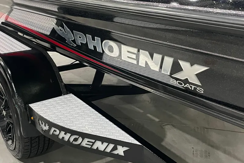 Slide: The Image of 2021 Phoenix 21 PHX boat trailer with logo and diamond plate accents. - 2