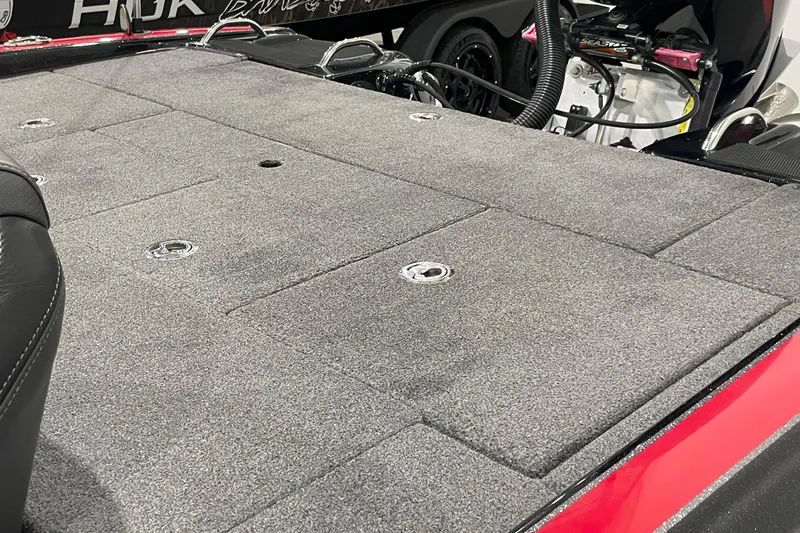 Slide: The Image of 2021 Phoenix 21 PHX boat deck with gray carpet and storage compartments. - 7