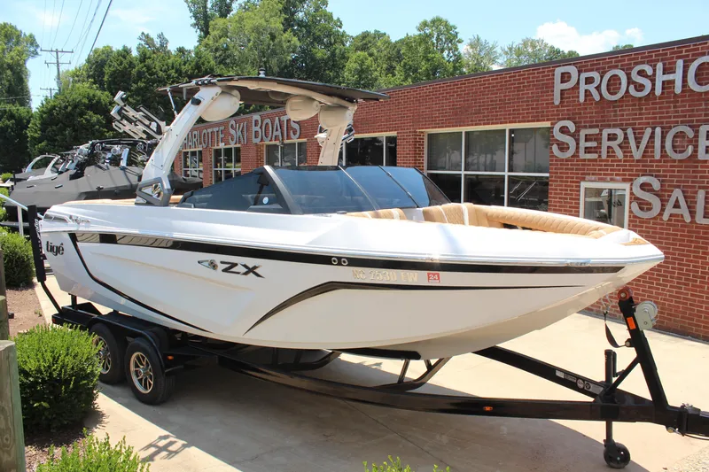 Slide: The Image of 2021 Tigé 23ZX boat on trailer at Charlotte Ski Boats dealership. - 1