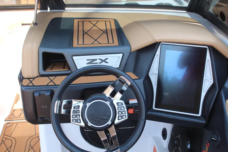 Slide: The Image of 2021 Tigé 23ZX boat dashboard with touchscreen and multifunction steering wheel. - 14