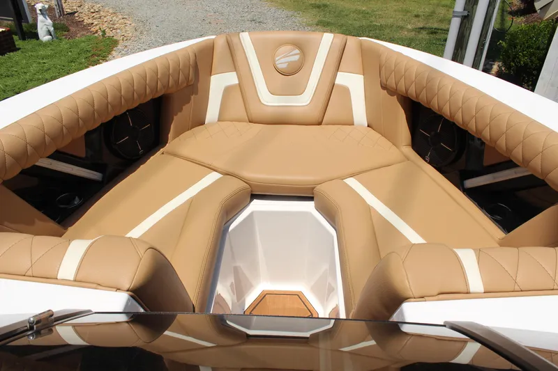 Slide: The Image of 2021 Tigé 23ZX boat interior with tan and white cushioned seating. - 15