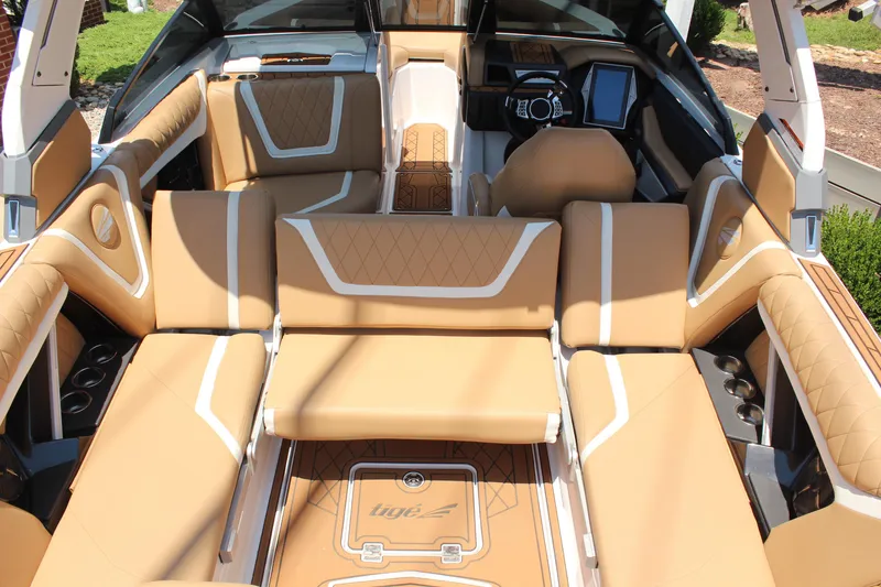 Slide: The Image of Luxurious interior of 2021 Tigé 23ZX boat with tan upholstery and modern dashboard. - 16