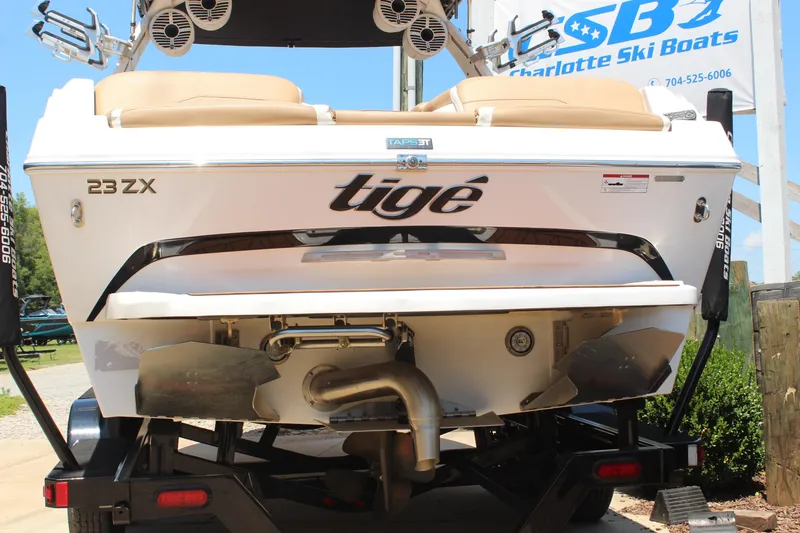 Slide: The Image of 2021 Tigé 23ZX boat rear view on trailer at Charlotte Ski Boats. - 4