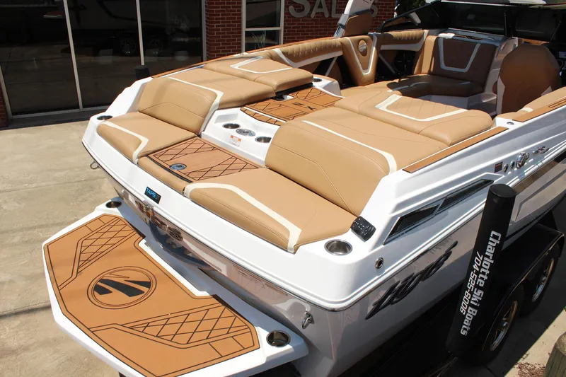 Slide: The Image of 2021 Tigé 23ZX boat with tan seating and sleek design, showcased outdoors. - 7